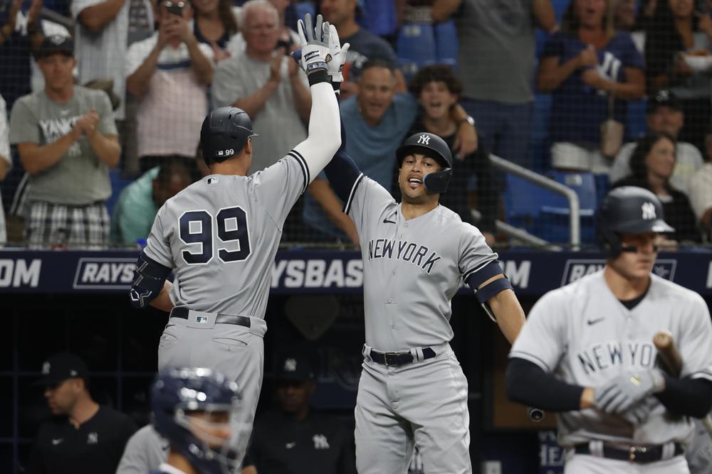 New York Yankees'' Giancarlo Stanton and Aaron Judge head to the outfield  together during game against the Atlanta Braves during a spring training  game at Champion Stadium in Kissimmee, Florida on March