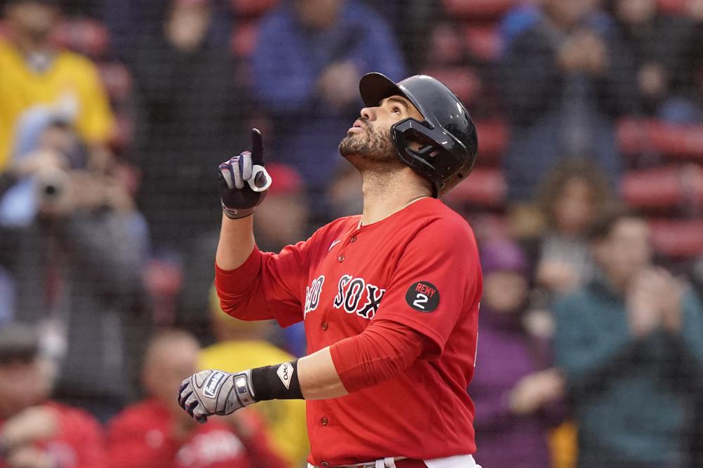 Boston Red Sox's Jonny Gomes places the championship trophy and a Red Sox  baseball jersey at the Boston Marathon Finish Line during a pause in their  World Series victory rolling rally in