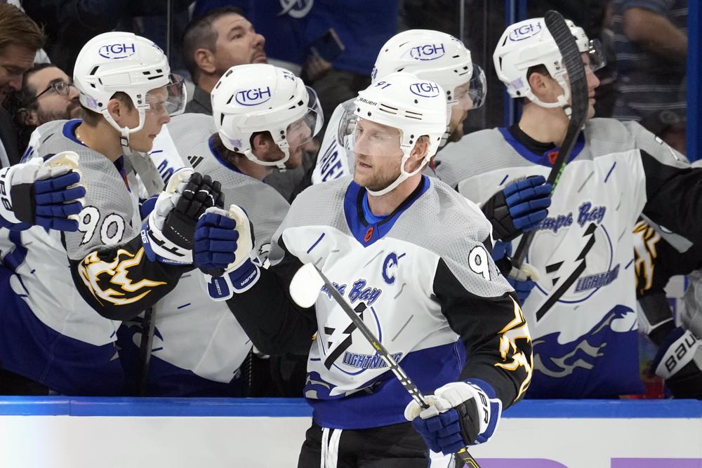 Tampa Bay Lightning center Steven Stamkos (91) celebrates with the bench after scoring against the Calgary Flames during the first period of an NHL hockey game Thursday, Nov. 17, 2022, in Tampa, Fla