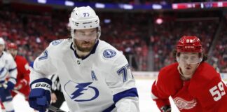 Tampa Bay Lightning defenseman Victor Hedman, left, and Detroit Red Wings left wing Tyler Bertuzzi chase the puck during the second period of an NHL hockey game, Saturday, Feb. 25, 2023, in Detroit.