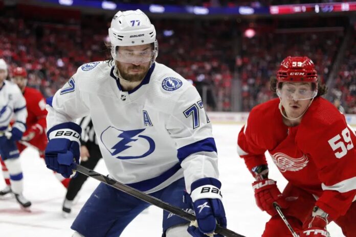 Tampa Bay Lightning defenseman Victor Hedman, left, and Detroit Red Wings left wing Tyler Bertuzzi chase the puck during the second period of an NHL hockey game, Saturday, Feb. 25, 2023, in Detroit.