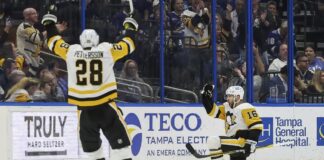 Pittsburgh Penguins' Jason Zucker (16) celebrates after his goal against the Tampa Bay Lightning with Marcus Pettersson during the second period of an NHL hockey game Thursday, March 2, 2023, in Tampa, Fla.