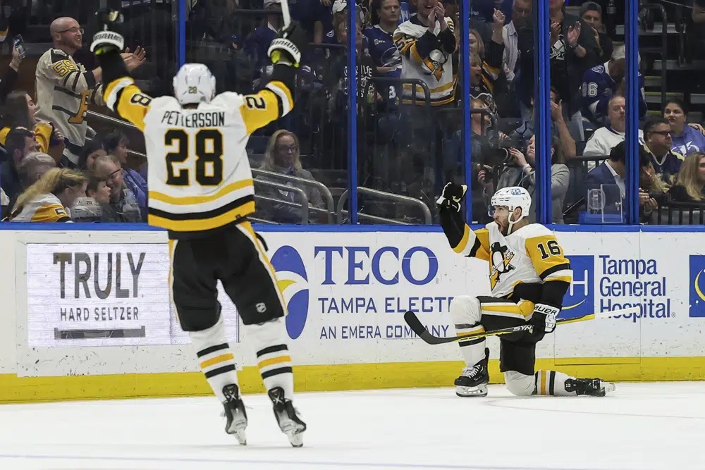 Pittsburgh Penguins' Jason Zucker (16) celebrates after his goal against the Tampa Bay Lightning with Marcus Pettersson during the second period of an NHL hockey game Thursday, March 2, 2023, in Tampa, Fla.