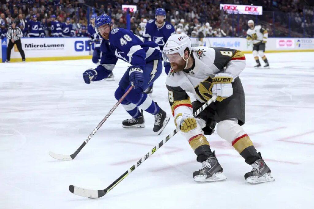 Vegas Golden Knights' Phil Kessel (8) avoids the defense of Tampa Bay Lightning's Nick Perbix during the first period of an NHL hockey game Thursday, March 9, 2023, in Tampa, Fla