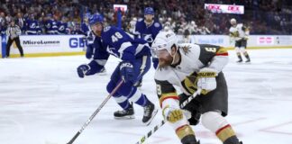 Vegas Golden Knights' Phil Kessel (8) avoids the defense of Tampa Bay Lightning's Nick Perbix during the first period of an NHL hockey game Thursday, March 9, 2023, in Tampa, Fla