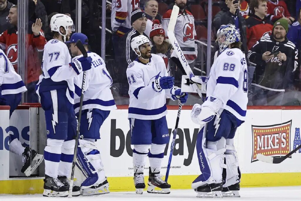 Tampa Bay Lightning left wing Pierre-Edouard Bellemare (41) celebrates with Andrei Vasilevskiy (88) after defeating the New Jersey Devils in an NHL hockey game Tuesday, March 14, 2023, in Newark, N.J. The Lightning won 4-1.