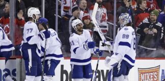 Tampa Bay Lightning left wing Pierre-Edouard Bellemare (41) celebrates with Andrei Vasilevskiy (88) after defeating the New Jersey Devils in an NHL hockey game Tuesday, March 14, 2023, in Newark, N.J. The Lightning won 4-1.