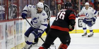 Tampa Bay Lightning's Victor Hedman (77) controls the puck in front of Carolina Hurricanes' Brady Skjei (76) during the first period of an NHL hockey game in Raleigh, N.C., Tuesday, March 28, 2023.