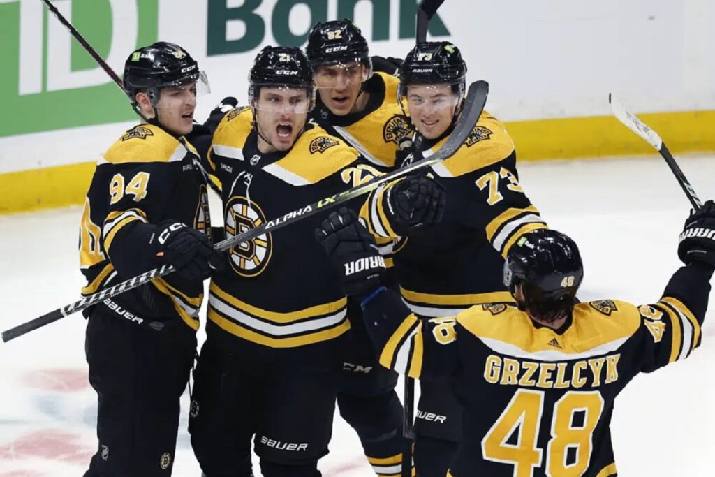 Boston Bruins' Garnet Hathaway (21) celebrates his goal with teammates during the second period of an NHL hockey game against the Tampa Bay Lightning, Saturday, March 25, 2023, in Boston.