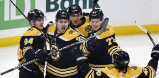 Boston Bruins' Garnet Hathaway (21) celebrates his goal with teammates during the second period of an NHL hockey game against the Tampa Bay Lightning, Saturday, March 25, 2023, in Boston.
