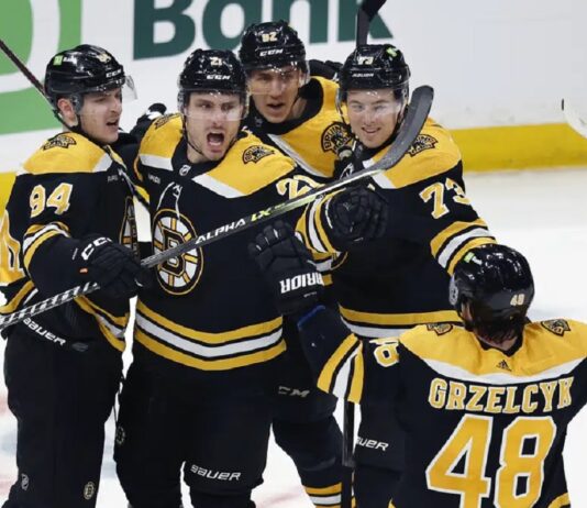 Boston Bruins' Garnet Hathaway (21) celebrates his goal with teammates during the second period of an NHL hockey game against the Tampa Bay Lightning, Saturday, March 25, 2023, in Boston.