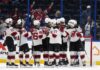 The New Jersey Devils celebrate after the team defeated the Tampa Bay Lightning during an NHL hockey game Sunday, March 19, 2023, in Tampa, Fla.