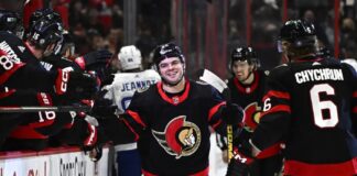 Ottawa Senators right wing Alex DeBrincat (12) celebrates after his second goal against the Tampa Bay Lightning with teammates during first-period NHL hockey game action in Ottawa, Thursday, March 23, 2023.