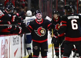 Ottawa Senators right wing Alex DeBrincat (12) celebrates after his second goal against the Tampa Bay Lightning with teammates during first-period NHL hockey game action in Ottawa, Thursday, March 23, 2023.