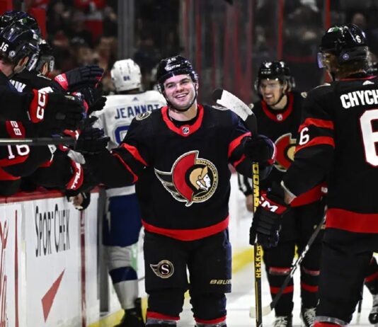Ottawa Senators right wing Alex DeBrincat (12) celebrates after his second goal against the Tampa Bay Lightning with teammates during first-period NHL hockey game action in Ottawa, Thursday, March 23, 2023.