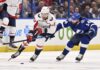 Washington Capitals right wing Tom Wilson (43) and Tampa Bay Lightning left wing Pat Maroon (14) battle for the puck during the first period of an NHL hockey game Thursday, March 30, 2023, in Tampa, Fla.