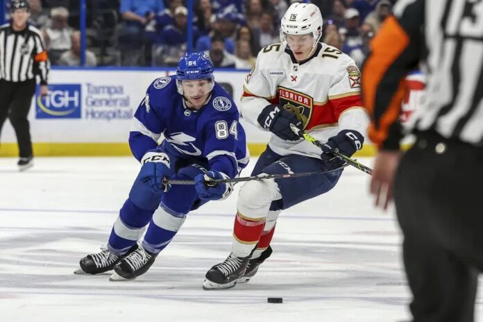 Tampa Bay Lightning's Tanner Jeannot and Florida Panthers' Anton Lundell compete for the puck during the second period of an NHL hockey game Tuesday, Feb. 28, 2023, in Tampa, Fla.