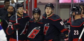 Carolina Hurricanes' Shayne Gostisbehere celebrates his goal with teammates Jesperi Kotkaniemi, Martin Necas, and Carolina Hurricanes' Stefan Noesen (23) during the second period of an NHL hockey game against the Tampa Bay Lightning in Raleigh, N.C., Sunday, March 5, 2023.