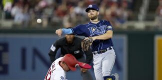 Washington Nationals' Alex Call, left, is out as Tampa Bay Rays second baseman Brandon Lowe throws to first base for the double play during the third inning of a baseball game at Nationals Park, Tuesday, April 4, 2023, in Washington.