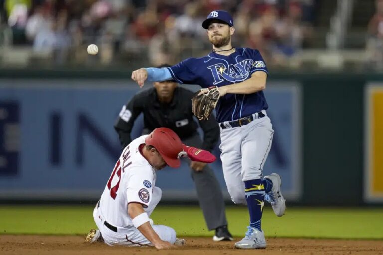 Washington Nationals' Alex Call, left, is out as Tampa Bay Rays second baseman Brandon Lowe throws to first base for the double play during the third inning of a baseball game at Nationals Park, Tuesday, April 4, 2023, in Washington.