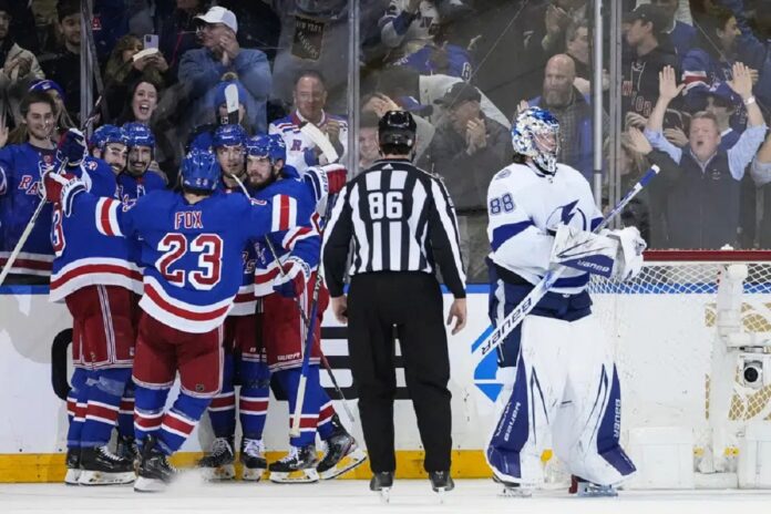 Tampa Bay Lightning goaltender Andrei Vasilevskiy (88) stands near the goal as the New York Rangers celebrate a goal by Chris Kreider during the third period of an NHL hockey game Wednesday, April 5, 2023, in New York. The Rangers won 6-3.