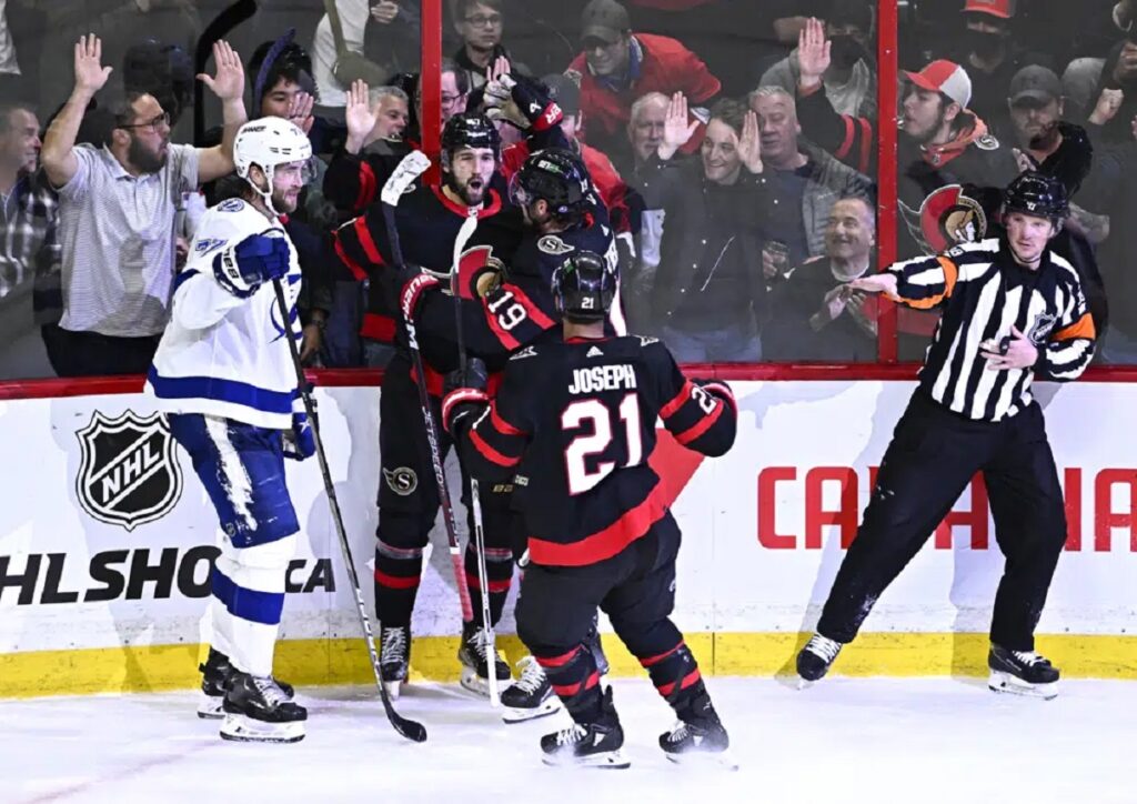 Ottawa Senators center Mark Kastelic (47) celebrates after a goal as Tampa Bay Lightning defenseman Victor Hedman (77) skates away during third-period NHL hockey game action in Ottawa, Ontario, Saturday, April 8, 2023. (Justin Tang/The Canadian Press via AP)