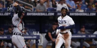 Tampa Bay Rays' Yandy Diaz, right, runs past Detroit Tigers catcher Eric Haase, left, to score during the third inning of a baseball game Saturday, April 1, 2023, in St. Petersburg, Fla. (AP Photo/Scott Audette)