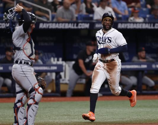 Tampa Bay Rays' Yandy Diaz, right, runs past Detroit Tigers catcher Eric Haase, left, to score during the third inning of a baseball game Saturday, April 1, 2023, in St. Petersburg, Fla. (AP Photo/Scott Audette)