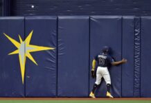 Tampa Bay Rays center fielder Manuel Margot can only watch as a fly ball hit by Philadelphia Phillies' Nick Castellanos flies over the wall for a home run during the sixth inning of a baseball game