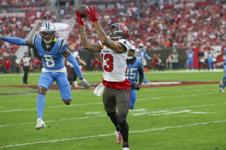 Evans scores on 75-yard TD, tops 1,000 yards for 10th straight year; Bucs beat Panthers 21-18