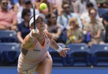 Caroline Dolehide, of the United States, returns a shot to Danielle Collins, of the United States, during the first round of the U.S. Open tennis championships, Tuesday, Aug. 27, 2024, in New York. (AP Photo/Seth Wenig)