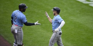 Tampa Bay Rays' Taylor Walls, right, celebrates his home run with Yandy Diaz (2) during the third inning of a baseball game against the Baltimore Orioles, Saturday, Sept. 7, 2024, in Baltimore. (AP Photo/Nick Wass)