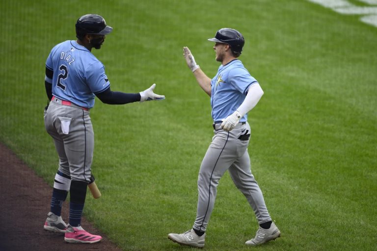 Tampa Bay Rays' Taylor Walls, right, celebrates his home run with Yandy Diaz (2) during the third inning of a baseball game against the Baltimore Orioles, Saturday, Sept. 7, 2024, in Baltimore. (AP Photo/Nick Wass)