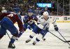 Tampa Bay Lightning center Brayden Point, right, drives witht he puck past Colorado Avalanche defenseman Cale Makar, front left, and center Nathan MacKinnon in the second period of an NHL hockey game Wednesday, Oct. 30, 2024, in Denver. (AP Photo/David Zalubowski)