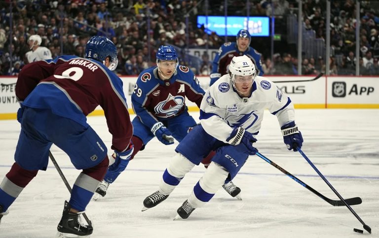 Tampa Bay Lightning center Brayden Point, right, drives witht he puck past Colorado Avalanche defenseman Cale Makar, front left, and center Nathan MacKinnon in the second period of an NHL hockey game Wednesday, Oct. 30, 2024, in Denver. (AP Photo/David Zalubowski)