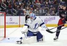 Columbus Blue Jackets forward Dmitri Voronkov, right, watches a goal by teammate Zach Werenski (not shown) get past Tampa Bay Lightning goalie Jonas Johansson, left, during the second period of an NHL hockey game in Columbus, Ohio, Thursday, Nov. 21, 2024. (AP Photo/Paul Vernon)