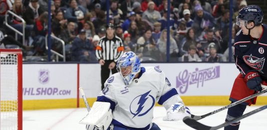 Columbus Blue Jackets forward Dmitri Voronkov, right, watches a goal by teammate Zach Werenski (not shown) get past Tampa Bay Lightning goalie Jonas Johansson, left, during the second period of an NHL hockey game in Columbus, Ohio, Thursday, Nov. 21, 2024. (AP Photo/Paul Vernon)