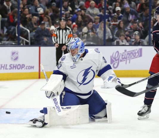 Columbus Blue Jackets forward Dmitri Voronkov, right, watches a goal by teammate Zach Werenski (not shown) get past Tampa Bay Lightning goalie Jonas Johansson, left, during the second period of an NHL hockey game in Columbus, Ohio, Thursday, Nov. 21, 2024. (AP Photo/Paul Vernon)