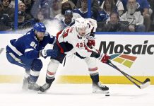 Tampa Bay Lightning defenseman Erik Cernak (81) and Washington Capitals right wing Tom Wilson battle for the puck during the second period of an NHL hockey game, Wednesday, Nov. 27, 2024, in Tampa, Fla. (AP Photo/Jason Behnken)