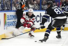 New Jersey Devils center Jack Hughes (86) slips the puck away from Tampa Bay Lightning defenseman Erik Cernak (81) during the first period of an NHL hockey game Saturday, Nov. 16, 2024, in Tampa, Fla. (AP Photo/Chris O'Meara)