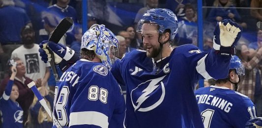 Tampa Bay Lightning defenseman Victor Hedman (77) hugs goaltender Andrei Vasilevskiy (88) after Vasilevskiy picked up his 300th career win during an NHL hockey game against the Winnipeg Jets Thursday, Nov. 14, 2024, in Tampa, Fla. (AP Photo/Chris O'Meara)