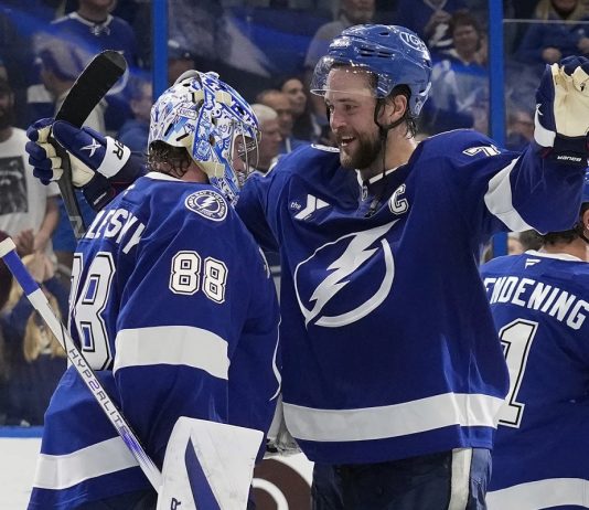 Tampa Bay Lightning defenseman Victor Hedman (77) hugs goaltender Andrei Vasilevskiy (88) after Vasilevskiy picked up his 300th career win during an NHL hockey game against the Winnipeg Jets Thursday, Nov. 14, 2024, in Tampa, Fla. (AP Photo/Chris O'Meara)