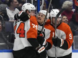 Philadelphia Flyers right wing Owen Tippett (74) celebrates his goal against the Tampa Bay Lightning with right wing Travis Konecny (11) and defenseman Jamie Drysdale (9) during the third period of an NHL hockey game Thursday, Nov. 7, 2024, in Tampa, Fla. (AP Photo/Chris O'Meara)