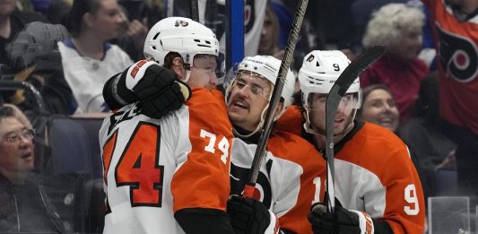 Philadelphia Flyers right wing Owen Tippett (74) celebrates his goal against the Tampa Bay Lightning with right wing Travis Konecny (11) and defenseman Jamie Drysdale (9) during the third period of an NHL hockey game Thursday, Nov. 7, 2024, in Tampa, Fla. (AP Photo/Chris O'Meara)