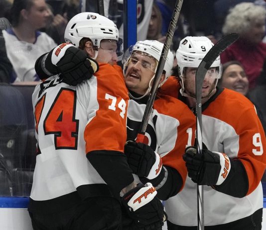 Philadelphia Flyers right wing Owen Tippett (74) celebrates his goal against the Tampa Bay Lightning with right wing Travis Konecny (11) and defenseman Jamie Drysdale (9) during the third period of an NHL hockey game Thursday, Nov. 7, 2024, in Tampa, Fla. (AP Photo/Chris O'Meara)