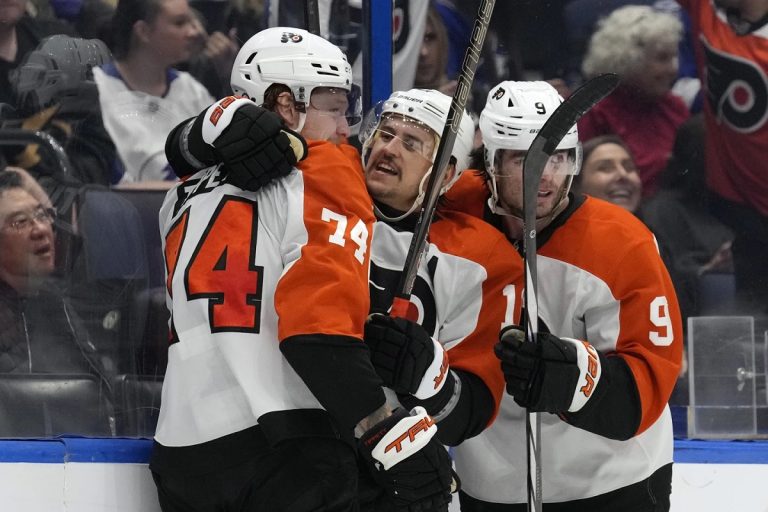 Philadelphia Flyers right wing Owen Tippett (74) celebrates his goal against the Tampa Bay Lightning with right wing Travis Konecny (11) and defenseman Jamie Drysdale (9) during the third period of an NHL hockey game Thursday, Nov. 7, 2024, in Tampa, Fla. (AP Photo/Chris O'Meara)