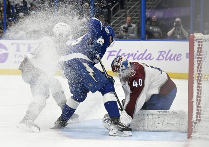 Colorado Avalanche goaltender Alexandar Georgiev (40) makes a save against Tampa Bay Lightning left wing Brandon Hagel (38) during the second period of an NHL hockey game Monday, Nov. 25, 2024, in Tampa, Fla. (AP Photo/Jason Behnken)