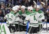 Dallas Stars center Roope Hintz (24) celebrates his goal against the Tampa Bay Lightning with center Wyatt Johnston (53) and defenseman Miro Heiskanen (4) during the third period of an NHL hockey game Saturday, Nov. 23, 2024, in Tampa, Fla. (AP Photo/Chris O'Meara)