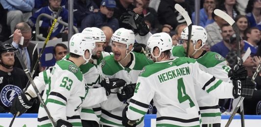 Dallas Stars center Roope Hintz (24) celebrates his goal against the Tampa Bay Lightning with center Wyatt Johnston (53) and defenseman Miro Heiskanen (4) during the third period of an NHL hockey game Saturday, Nov. 23, 2024, in Tampa, Fla. (AP Photo/Chris O'Meara)