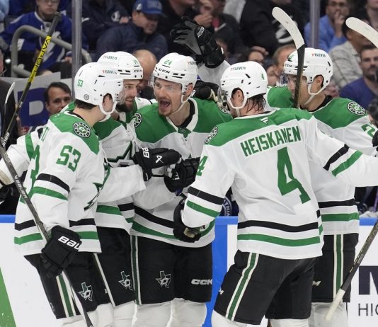 Dallas Stars center Roope Hintz (24) celebrates his goal against the Tampa Bay Lightning with center Wyatt Johnston (53) and defenseman Miro Heiskanen (4) during the third period of an NHL hockey game Saturday, Nov. 23, 2024, in Tampa, Fla. (AP Photo/Chris O'Meara)